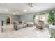 Relaxing living room with beige furniture, tile flooring and lots of plants at 1155 Kilkenny Ln, Ormond Beach, FL 32174