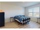 Bright bedroom with wood-look floors and large window at 126 Old Mill Pond Rd, Edgewater, FL 32141