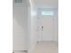 Bright entryway with white door and tile flooring at 126 Old Mill Pond Rd, Edgewater, FL 32141