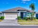 Single-story home with attached garage and well-manicured lawn at 126 Old Mill Pond Rd, Edgewater, FL 32141