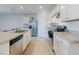 Modern kitchen with island, stainless steel appliances, and white cabinets at 126 Old Mill Pond Rd, Edgewater, FL 32141