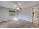 Well-lit bedroom featuring carpet flooring and ceiling fan at 1732 Travelers Palm Dr, Edgewater, FL 32132