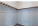 Roomy closet with wood shelving and hanging rod at 1732 Travelers Palm Dr, Edgewater, FL 32132