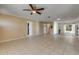 Open living space with tile floors and access to the kitchen and backyard at 1732 Travelers Palm Dr, Edgewater, FL 32132