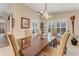 Bright dining room with a large table and plantation shutters at 1763 Weeping Elm Cir, Port Orange, FL 32128