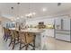 Island kitchen with granite countertops, white cabinetry, and breakfast bar at 1763 Weeping Elm Cir, Port Orange, FL 32128