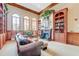 Library boasts a fireplace, comfortable seating, and built-in bookshelves at 1763 Weeping Elm Cir, Port Orange, FL 32128