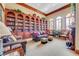 Relaxing library with comfortable seating and extensive bookshelves at 1763 Weeping Elm Cir, Port Orange, FL 32128