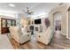 Spacious living room featuring hardwood floors, a fireplace, and comfortable seating at 1763 Weeping Elm Cir, Port Orange, FL 32128