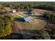 Aerial view of a house with a pool and fenced yard at 18459 Sw 66Th Loop, Dunnellon, FL 34432