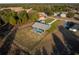 Aerial view of a house with a pool and fenced yard at 18459 Sw 66Th Loop, Dunnellon, FL 34432