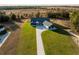 Aerial view of a house with a long driveway at 18459 Sw 66Th Loop, Dunnellon, FL 34432