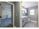 Stylish bathroom with gray vanity and a view into a Bedroom at 18459 Sw 66Th Loop, Dunnellon, FL 34432