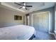 Spacious bedroom with ceiling fan and double doors to the bathroom at 18459 Sw 66Th Loop, Dunnellon, FL 34432