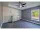 Bedroom with gray carpeting, shiplap wall, and a crib at 18459 Sw 66Th Loop, Dunnellon, FL 34432