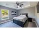 Comfortable bedroom with ceiling fan and large window at 18459 Sw 66Th Loop, Dunnellon, FL 34432