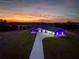 House with purple lighting at sunset. Modern design at 18459 Sw 66Th Loop, Dunnellon, FL 34432