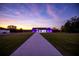 House with purple lighting at sunset. Modern design at 18459 Sw 66Th Loop, Dunnellon, FL 34432