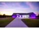 Single-story home with purple lighting at sunset. Modern design at 18459 Sw 66Th Loop, Dunnellon, FL 34432