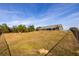 House back view, showcasing a large backyard at 18459 Sw 66Th Loop, Dunnellon, FL 34432