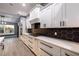 Modern kitchen with white cabinets, quartz countertops, and black hexagon backsplash at 18459 Sw 66Th Loop, Dunnellon, FL 34432