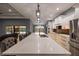 Large kitchen island with seating, quartz countertops, and black matte faucet at 18459 Sw 66Th Loop, Dunnellon, FL 34432