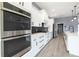 Modern kitchen with double oven, white cabinets, and black hexagon tile at 18459 Sw 66Th Loop, Dunnellon, FL 34432