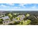 Aerial view of a charming villa community near water and a golf course at 1957 Turnbull Lakes Dr, New Smyrna Beach, FL 32168