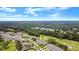 Aerial view showing a home's location in a community near a golf course at 1957 Turnbull Lakes Dr, New Smyrna Beach, FL 32168