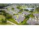 Aerial view showing a home nestled in a community near a golf course at 1957 Turnbull Lakes Dr, New Smyrna Beach, FL 32168