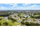 Aerial view highlighting a home's peaceful setting near water and a golf course at 1957 Turnbull Lakes Dr, New Smyrna Beach, FL 32168