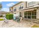 Relaxing patio with seating area, adjacent to the house and lush landscaping at 1957 Turnbull Lakes Dr, New Smyrna Beach, FL 32168