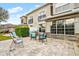 Stone paved patio with seating area and partial view of the backyard at 1957 Turnbull Lakes Dr, New Smyrna Beach, FL 32168