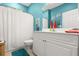 Bathroom with teal walls, white vanity, and shower/tub combo at 1957 Turnbull Lakes Dr, New Smyrna Beach, FL 32168