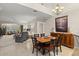 Elegant dining area with a wood table and chairs, and open living room view at 1957 Turnbull Lakes Dr, New Smyrna Beach, FL 32168