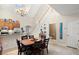 Open concept dining area with a wood table and chairs, near the kitchen and staircase at 1957 Turnbull Lakes Dr, New Smyrna Beach, FL 32168