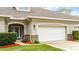 Two-story house with white garage door and stone accents at 1957 Turnbull Lakes Dr, New Smyrna Beach, FL 32168