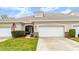 Attractive home exterior with two-car garage and landscaped yard at 1957 Turnbull Lakes Dr, New Smyrna Beach, FL 32168