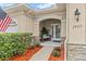 Front entry with stone accents, wood bench, and landscaping at 1957 Turnbull Lakes Dr, New Smyrna Beach, FL 32168