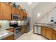 Modern kitchen featuring stainless steel appliances and wood cabinets at 1957 Turnbull Lakes Dr, New Smyrna Beach, FL 32168