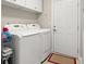 Bright laundry room with washer, dryer, and additional storage at 1957 Turnbull Lakes Dr, New Smyrna Beach, FL 32168