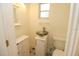 Clean and bright bathroom with toilet and sink at 1975 Lake Dr, New Smyrna Beach, FL 32168