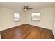 Well-lit bedroom featuring hardwood floors and a ceiling fan at 1975 Lake Dr, New Smyrna Beach, FL 32168