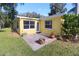 Bright yellow home exterior with a patio area at 1975 Lake Dr, New Smyrna Beach, FL 32168