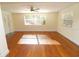 Bright living room with hardwood floors and a ceiling fan at 1975 Lake Dr, New Smyrna Beach, FL 32168