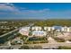 Aerial view of colorful condominiums along a canal and mangroves at 2 Riverwalk Dr # 402, New Smyrna Beach, FL 32169