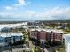 Aerial view showcasing condo buildings, parking, and waterfront access with boat docks at 2 Riverwalk Dr # 402, New Smyrna Beach, FL 32169