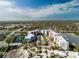 Aerial view highlighting the condo community, featuring a tennis court and waterfront access at 2 Riverwalk Dr # 402, New Smyrna Beach, FL 32169