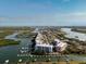 Scenic aerial view showcasing waterfront condos with boat docks and ocean views at 2 Riverwalk Dr # 402, New Smyrna Beach, FL 32169