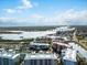 Wide aerial shot of condos with boat docks and a waterway leading to the ocean at 2 Riverwalk Dr # 402, New Smyrna Beach, FL 32169